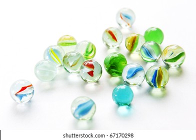 Brightly colored marbles in different shades on bright white