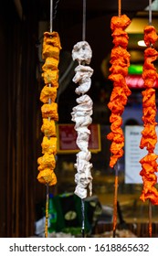 Brightly Colored Marinated Chicken On Long Skewers Outside An Indian Restaurant In Shimla, India