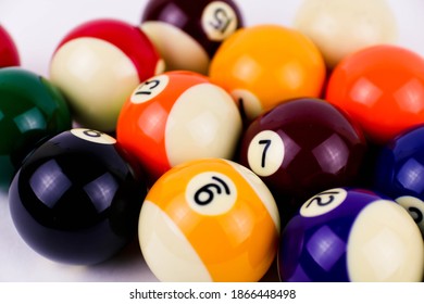 Brightly colored pool or billiard balls close up on white background. Soft focus