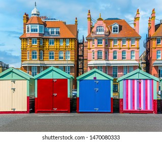 Brightly Coloured Beach Huts Adorn The Promenade In Hove, UK In Summertime