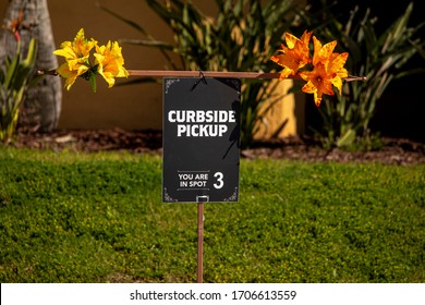 Brightly Decorated Curbside Pick Up Sign At Restaurant 