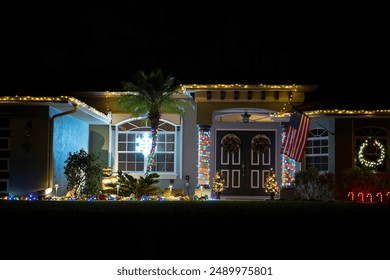 Brightly illuminated christmas decorations on front yard of florida family home. Outside decor for winter holidays - Powered by Shutterstock