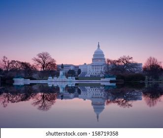 Brightly Lit Dawn Sky Behind The Illuminated Dome Of The Capitol In Washington DC With The Pool And Statues