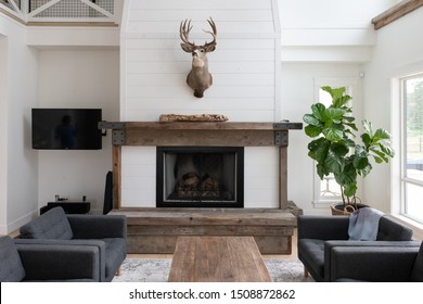 Brightly Lit Living Room Of A Modern Beach House Or Farmhouse. Featuring Reclaimed Wood And White Walls.