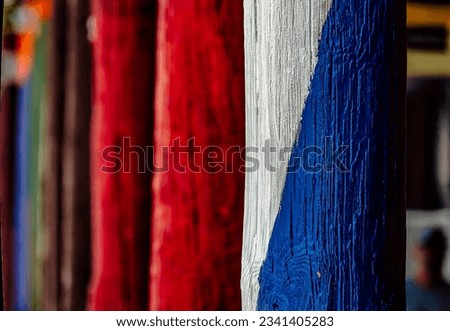 Brightly painted wooden poles in a row                               