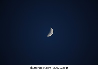 Brightly shining moon in a cloudless night sky