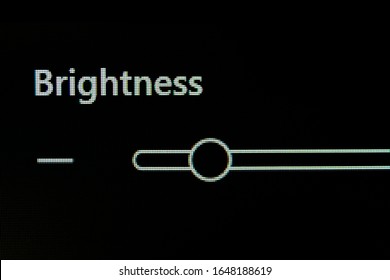 Brightness Adjustment Control Panel Of A Computer Monitor Screen With Slider To Adjust Brightness Level For Viewing Comfort And To Avoid Straining The Eye. Pixelated Image Of A LED Screen, Macro View.