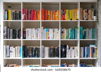 Brighton, England - August 03 2019: White Wooden Bookcase Filled With Books In A UK Home Setting