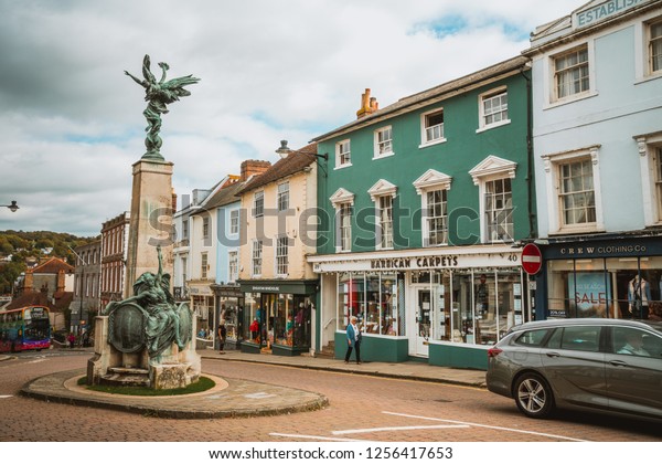 Brighton,\
England - October 3, 2018: Lewes conservation area at Wallands\
Park, East Sussex county town with roundabout, transportation,\
house, monument and front store in\
background.