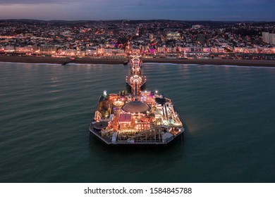 Brighton Palace Pier and Seafront Illuminated at Night on the South Coast of England - Powered by Shutterstock