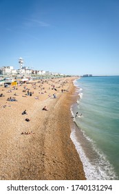 Brighton / UK - August 29 2017: People relaxing on Brighton beach on a sunny summers day