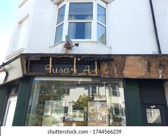 Brighton UK - May 28 2020 Shop Fascia Sign Being Replaced Revealing Old Fascia Sign With Part Of Old Shop Name