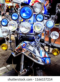 Brighton, United Kingdom - August 25, 2018: Front Of Mod Culture Scooter With Multiple Headlamps And Mirrors Also Showing Front Fender