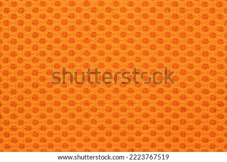 Brigth orange polyester mesh close up texture