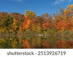 Brillant Autumn colors and a daytime moon over this pond in a Long Valley NJ park.