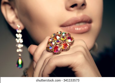 Brilliant. Antique old vintage earrings and ring. Jewelry on her finger at the girl close-up