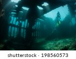 Brilliant beams of sunlight illuminate the remains of a shipwreck in the Solomon Islands. Many ships were sunk in this area during World War II. The wrecks now make artificial reefs.