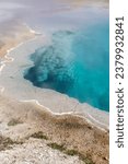 Brilliant blue thermal pool in West Thumb Basin in Yellowstone National Park