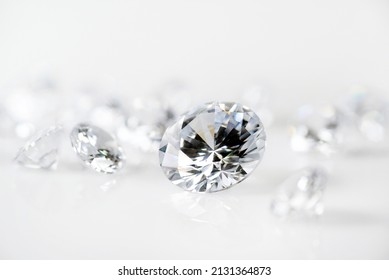 Brilliant Cut Diamond Held By Tweezers On White Background