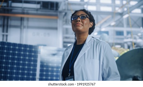 Brilliant Female Engineer Looking Around In Wonder At The Aerospace Satellite Manufacturing Facility. Young Talent Starting Her Career In World Top Science And Technology Space Exploration Program