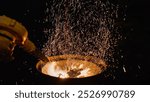 Brilliant Sparks flying dramatically from the firepit in a dark setting, showcasing raw energy of fire at night. Industrial dryer for blowing fire. High quality photo