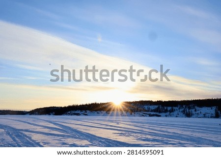 Brilliant sunset casting long shadows over winter snow