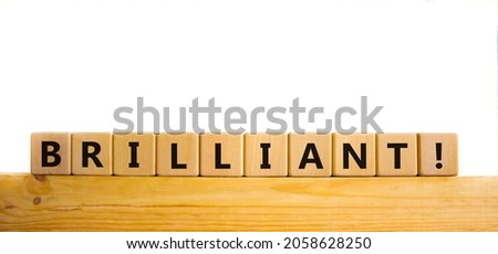 Brilliant symbol. The word brilliant on wooden cubes. Beautiful wooden table, white background. Business and brilliant concept. Copy space.
