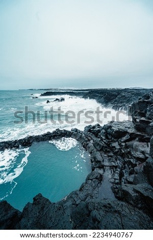 Brimketill lava rock pool - natural pool at the bottom of the cliffs, located on the Reykjanes Peninsula, west of the Grindavik, Iceland.