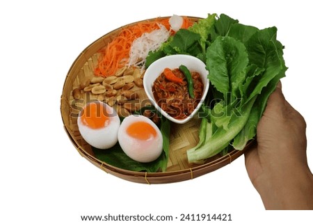 Bring a tray of chili paste, boiled eggs, fresh vegetables, shredded carrots, and roasted peanuts. on a white background