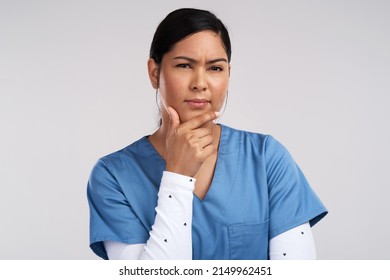 Bring your best wounds, dress them up just for you. Portrait of a young beautiful doctor deep in thought against a white background. - Powered by Shutterstock