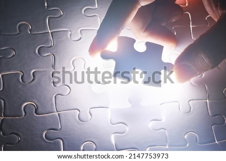 Bringing it all together. Conceptual shot of a persons hand building a puzzle.