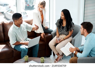 Bringing Together Their Ideas To Craft Something Amazing. Shot Of A Group Of Businesspeople Having A Discussion In An Office.