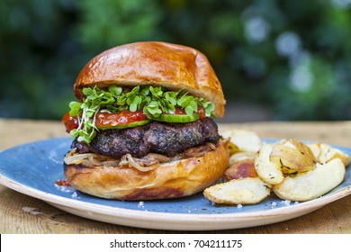 Brioche Bun With Burger, Fried Onions, Pickled Cucumber And Cress