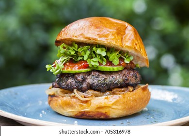 Brioche Bun With Burger, Fried Onions, Pickled Cucumber And Cress