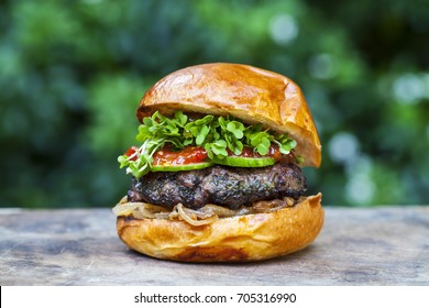 Brioche Bun With Burger, Fried Onions, Pickled Cucumber And Cress