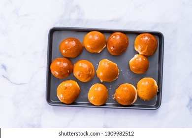 Brioche Mini Hamburger Buns On A Baking Sheet.