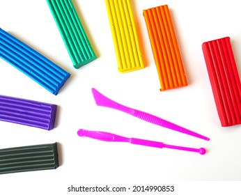 Briquettes of colored plasticine are laid out on a white background. Plasticine cutting stack. Concept for creative articles. Cover layout for modeling courses. - Shutterstock ID 2014990853