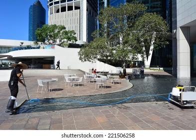 BRISBANE, AUS - SEP 25 2014:Swimming Pool Service Technician Clean A Pool. There Are About 15,000,000 Residential Pools And Spas In The United States