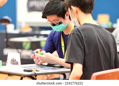 Brisbane, Australia - APRIL 02 2022: Brisbane Autumn 2022 Speedcubing Competition, Competitor Mid Solve 3x3x3 Cube Event, First Round.