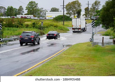 Brisbane, Australia - December 13, 2020: Vehicles Drive Through A Flooded Road. The La Nina Weather Event Has Bought Above Average Rainfall. 