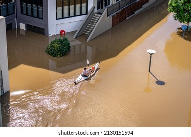Brisbane, Australia - Feb 28, 2022: Man kayaking along the flooded streets of West End suburb