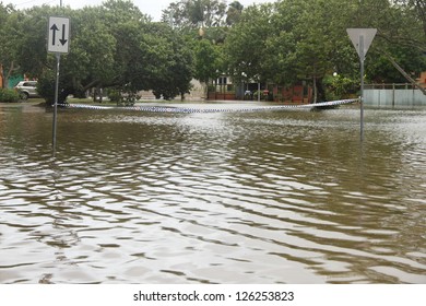 BRISBANE, AUSTRALIA - JANUARY 28 : Police Tape Accross Flooded Street From Ex Tropical Cyclone Oswald On January 28, 2013 In Brisbane, Australia