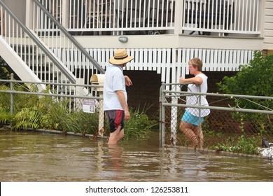 BRISBANE, AUSTRALIA - JANUARY 28 : Unidentified Residents Chat In Flood Waters From Ex Tropical Cyclone Oswald On January 28, 2013 In Brisbane, Australia