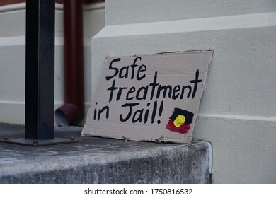 Brisbane, Australia - June 06, 2020: Sign resting agains a wall wishing for better treatments of aborigines in police custody. Since 1991, 432 aborigines have died at the hands of police in Australia.