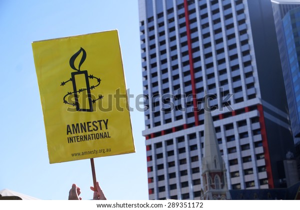 BRISBANE, AUSTRALIA - JUNE 20: Amnesty\
International placard at World Refugee Day Rally\
