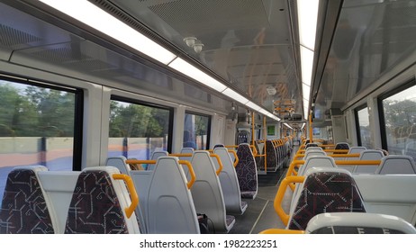 Brisbane, Australia - May 2021: Focus On Right Front Seat, View Of Rows Of Empty Seat On Moving Train Or Commuter. Subway Carriages