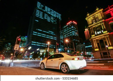 BRISBANE, AUSTRALIA - OCTOBER 05, 2012 : Brisbane City Traffic Along Victoria Bridge And The Junction With A White Car And The Lights Of Vehicles Passing By