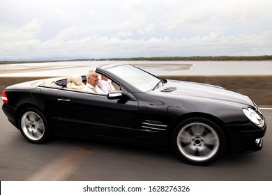 Brisbane, QLD Australia 01/25/2020: A Black Classy Convertible Sports Car With A Mature Couple Taking A Cruise.