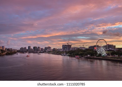 Brisbane, QLD / Australia - 02 03 2018: Brisbane City Cbd Central At Dusk With Pink Cloudy Skies Over The Building Skyscrapers Cranes Busy Highway Traffic And Brisbane Rivers Ferries