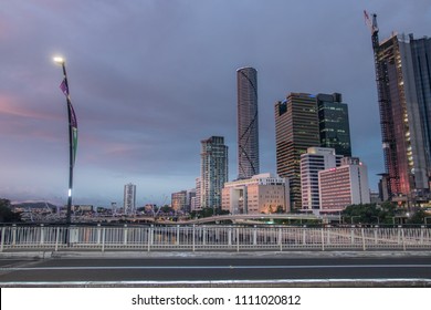 Brisbane, QLD / Australia - 02 03 2018: Brisbane City Cbd Central At Dusk With Pink Cloudy Skies Over The Building Skyscrapers Cranes Busy Highway Traffic And Brisbane Rivers Ferries